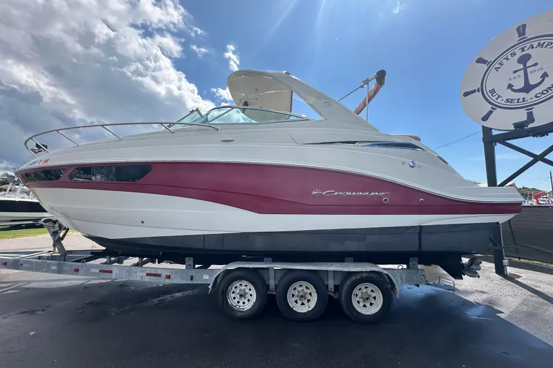 Slide: The Image of 2017 Crownline 294 CR boat on trailer under cloudy sky. - 5