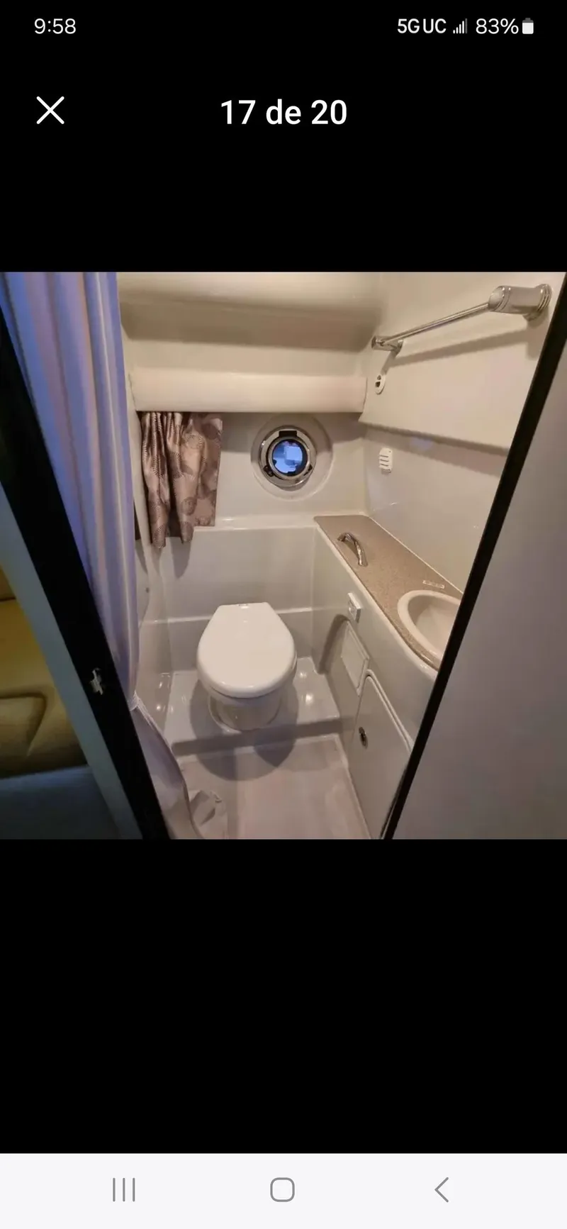Slide: The Image of 2017 Crownline 294 CR boat bathroom with toilet, sink, and porthole window. - 59