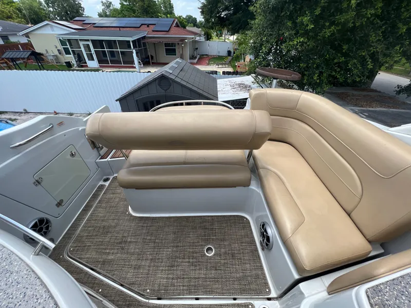 Slide: The Image of 2017 Crownline 294 CR boat interior with beige seating and carpeted flooring. - 67