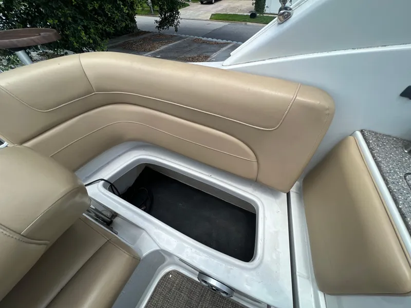 Slide: The Image of 2017 Crownline 294 CR boat with beige seating and open storage compartment. - 68