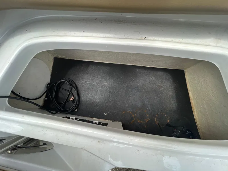 Slide: The Image of 2017 Crownline 294 CR storage compartment with coiled cable inside. - 69