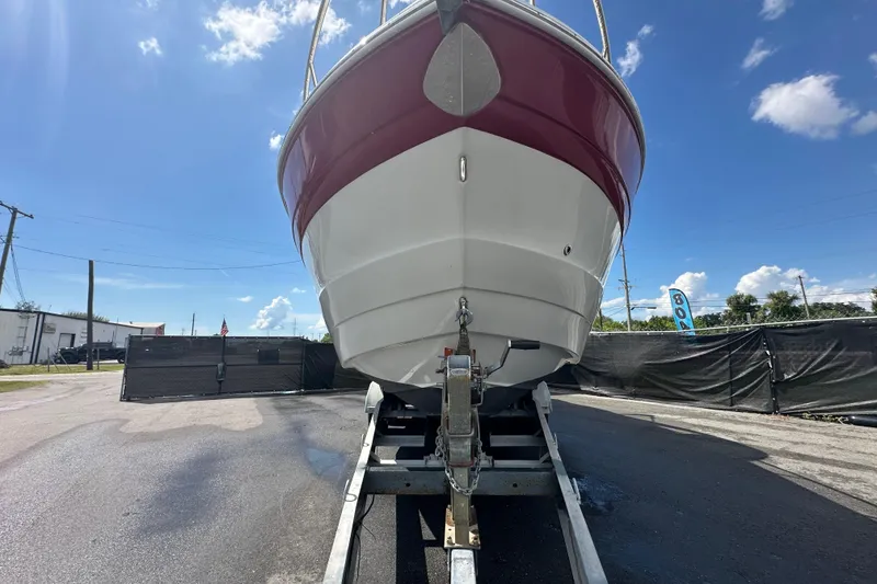 Slide: The Image of 2017 Crownline 294 CR boat on trailer under clear blue sky. - 7