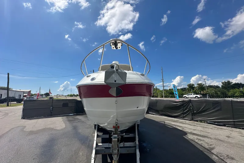 Slide: The Image of 2017 Crownline 294 CR boat on trailer under clear blue sky. - 8