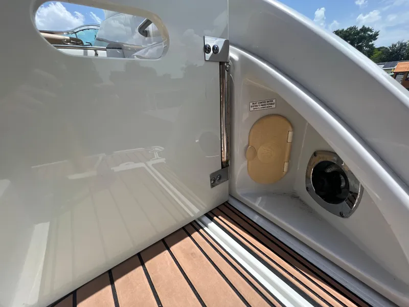 Slide: The Image of 2017 Crownline 294 CR boat interior with teak flooring and access panel. - 81