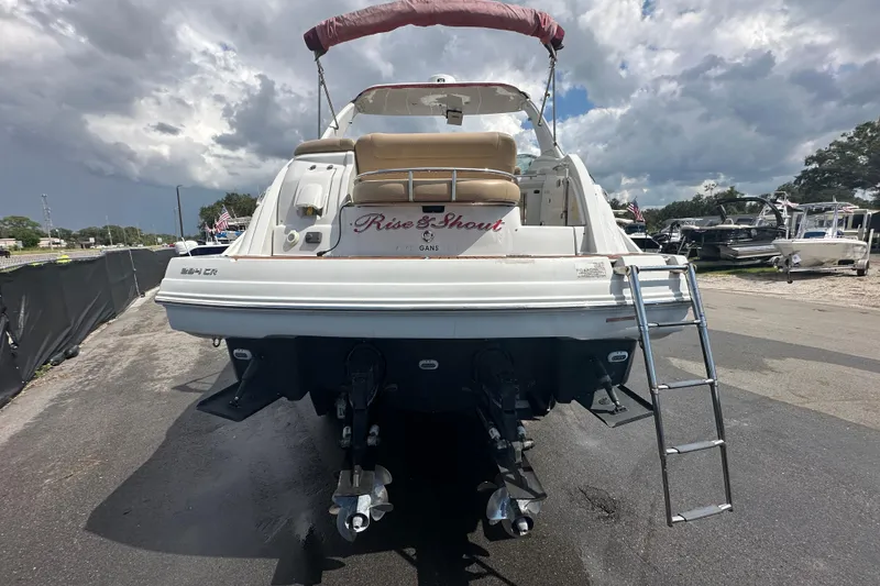 Slide: The Image of 2017 Crownline 294 CR boat with ladder, docked under cloudy sky. - 9