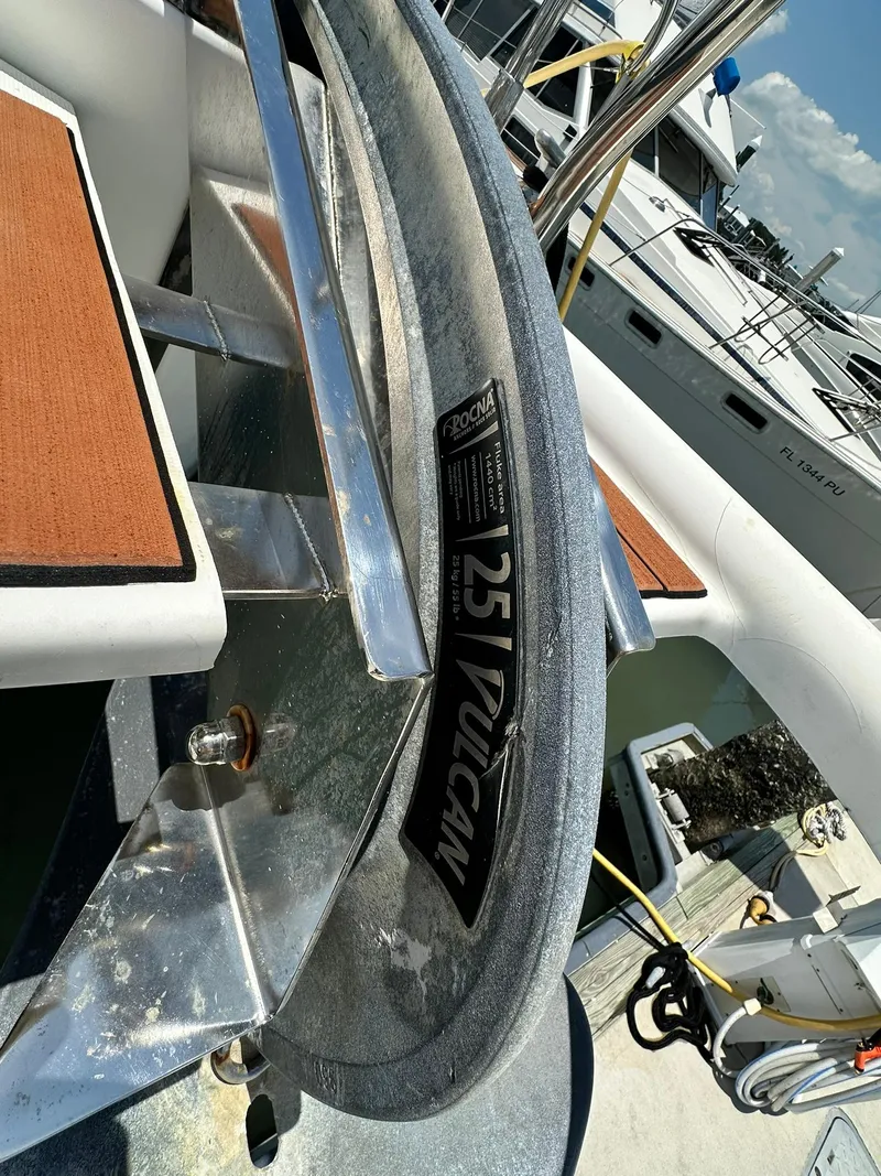 Slide: The Image of Anchor on 2005 Beneteau Swift Trawler 42, docked with other boats in background. - 15