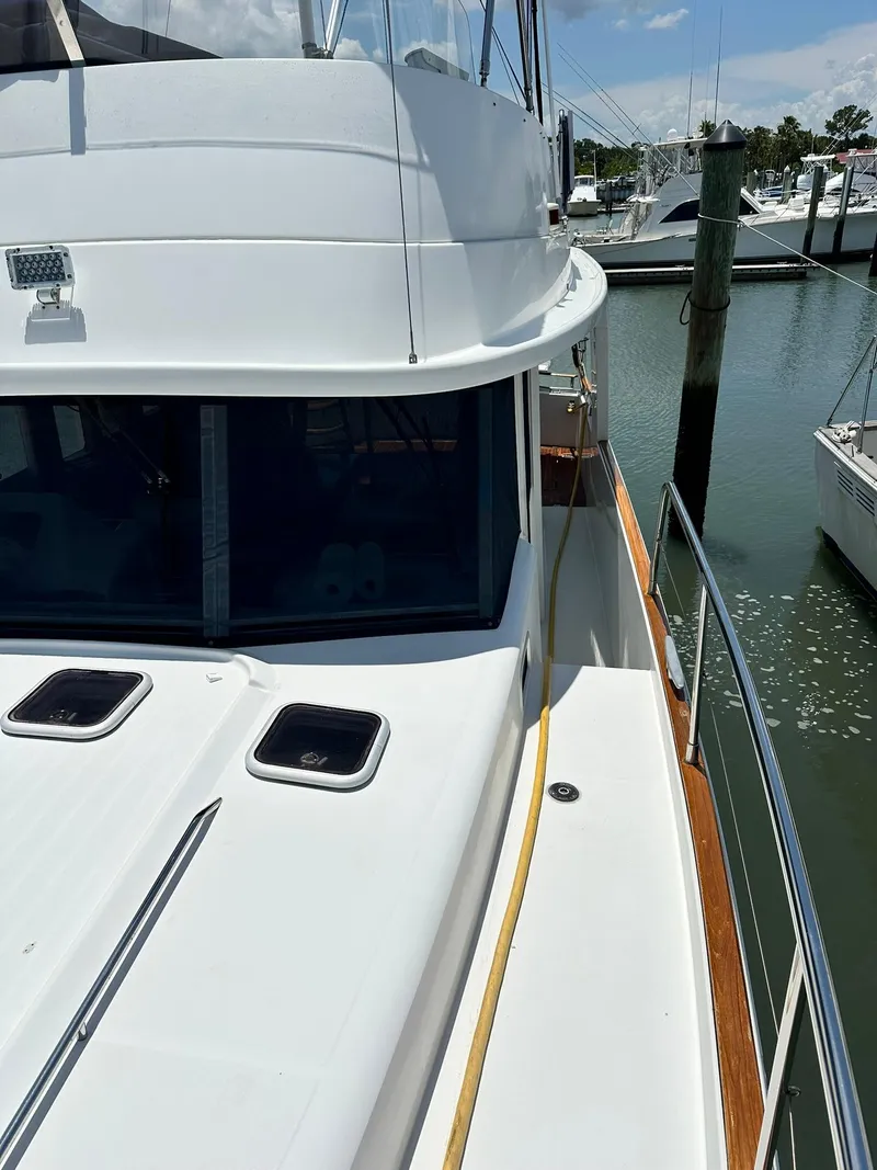 Slide: The Image of 2005 Beneteau Swift Trawler 42 docked at marina, side view. - 19