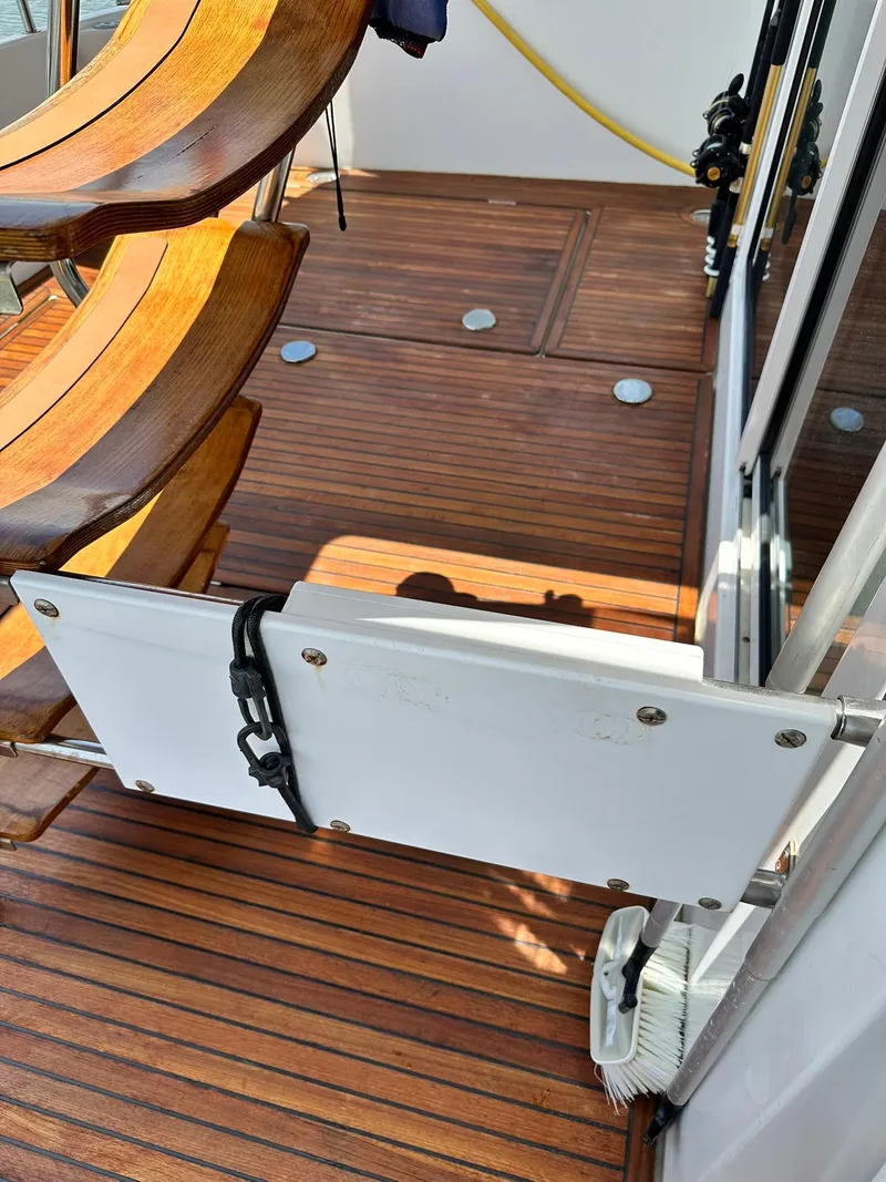 Slide: The Image of Wooden deck of a 2005 Beneteau Swift Trawler 42 with seating and safety gate. - 23