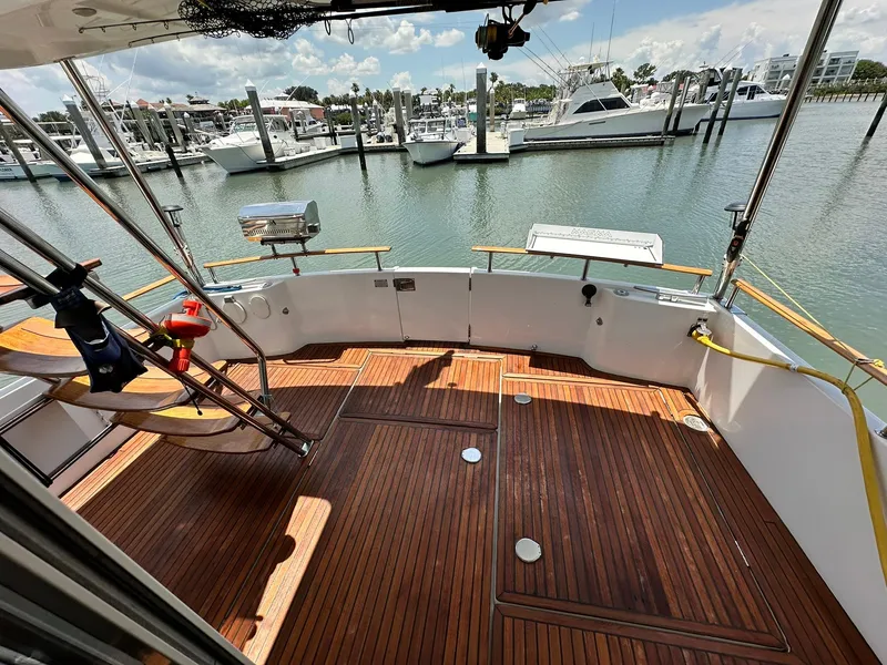 Slide: The Image of 2005 Beneteau Swift Trawler 42 with wooden deck, docked at marina. - 27