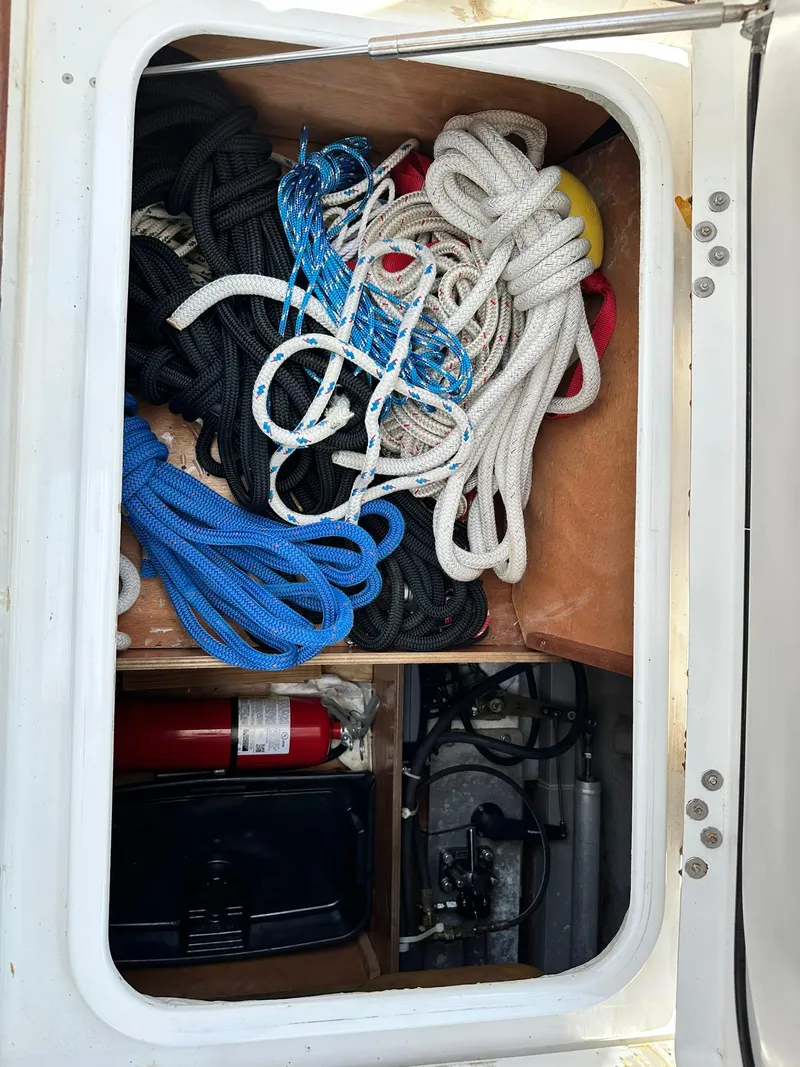Slide: The Image of Storage compartment with ropes and fire extinguisher on a 2005 Beneteau Swift Trawler 42. - 35