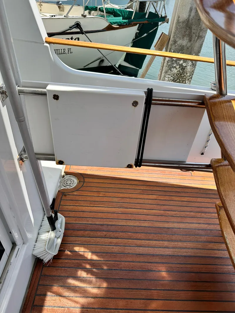 Slide: The Image of 2005 Beneteau Swift Trawler 42 deck with wooden flooring and stairs. - 36