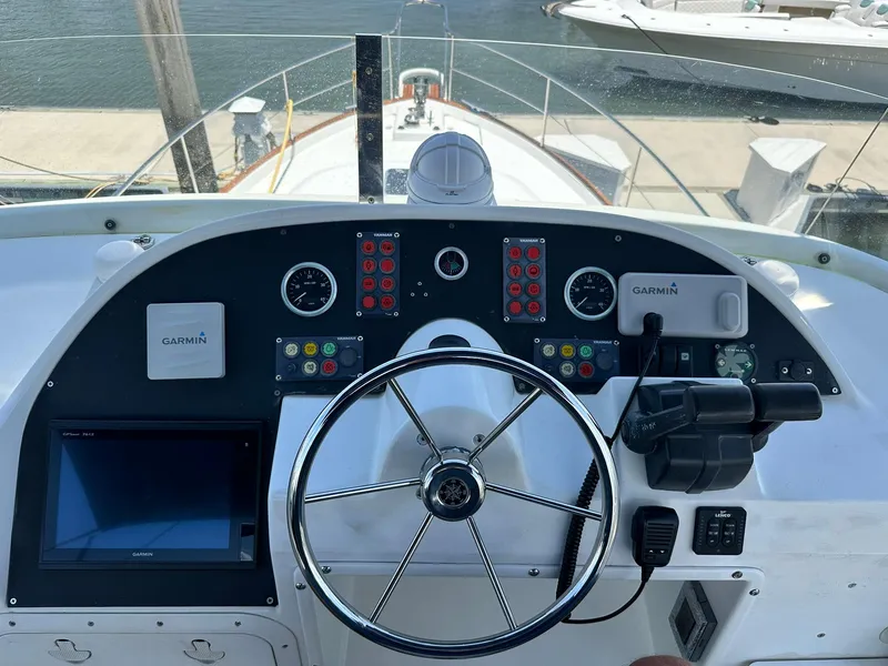 Slide: The Image of Helm of 2005 Beneteau Swift Trawler 42 with Garmin navigation system and steering wheel. - 45