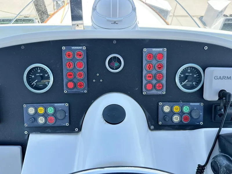 Slide: The Image of Control panel of a 2005 Beneteau Swift Trawler 42 with gauges and switches. - 48