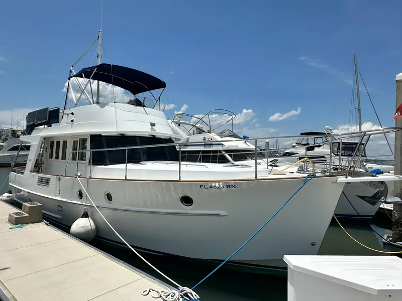 Slide: The Image of 2005 Beneteau Swift Trawler 42 docked at marina under clear blue sky. - 5