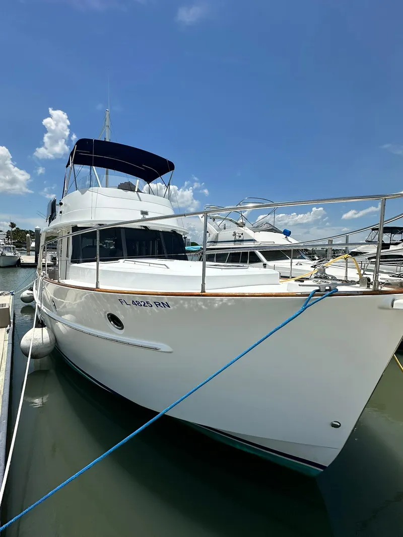 Slide: The Image of 2005 Beneteau Swift Trawler 42 docked at marina under clear blue sky. - 6