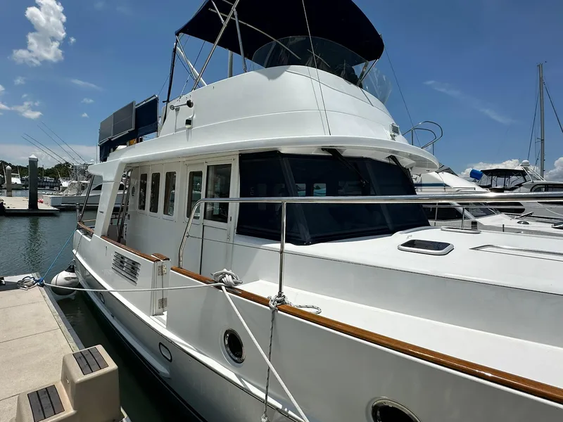 Slide: The Image of 2005 Beneteau Swift Trawler 42 docked at marina under clear blue sky. - 7