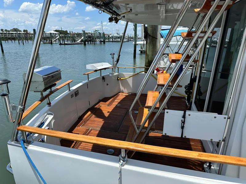 Slide: The Image of 2005 Beneteau Swift Trawler 42, wooden deck, docked at marina, sunny day. - 9