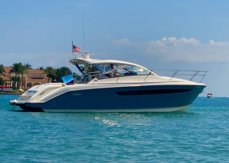 Slide: The Image of 2014 Pursuit SC 365i Sport Coupe on clear blue water, sunny day. - 0