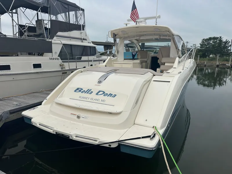Slide: The Image of 2014 Pursuit SC 365i Sport Coupe docked, rear view with "Bella Dona" name. - 1