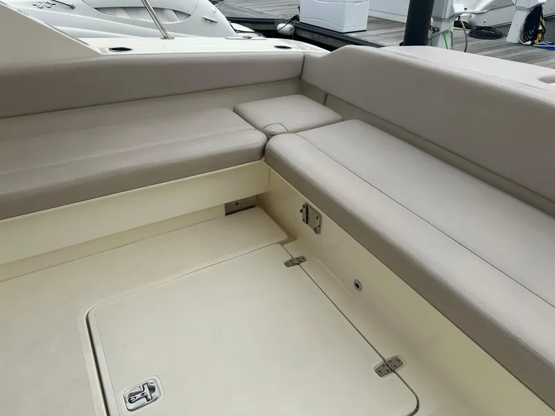 Slide: The Image of 2014 Pursuit SC 365i Sport Coupe interior seating area with beige upholstery. - 11