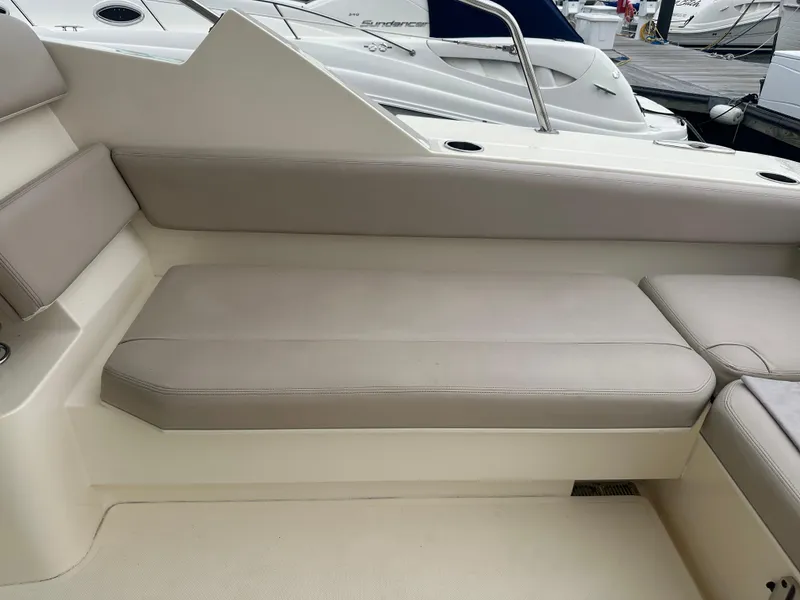 Slide: The Image of 2014 Pursuit SC 365i Sport Coupe interior seating with beige cushions. - 15