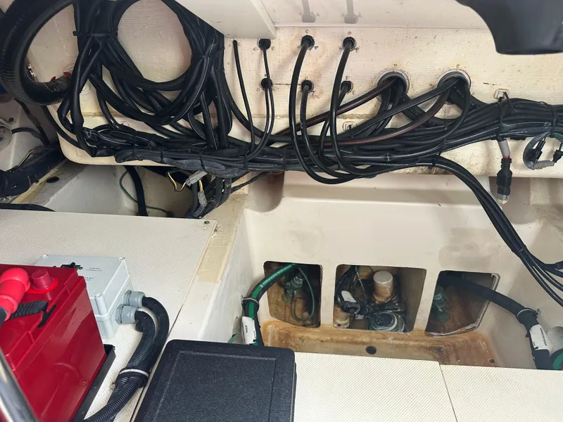 Slide: The Image of Engine compartment of a 2014 Pursuit SC 365i Sport Coupe with visible wiring and battery. - 17