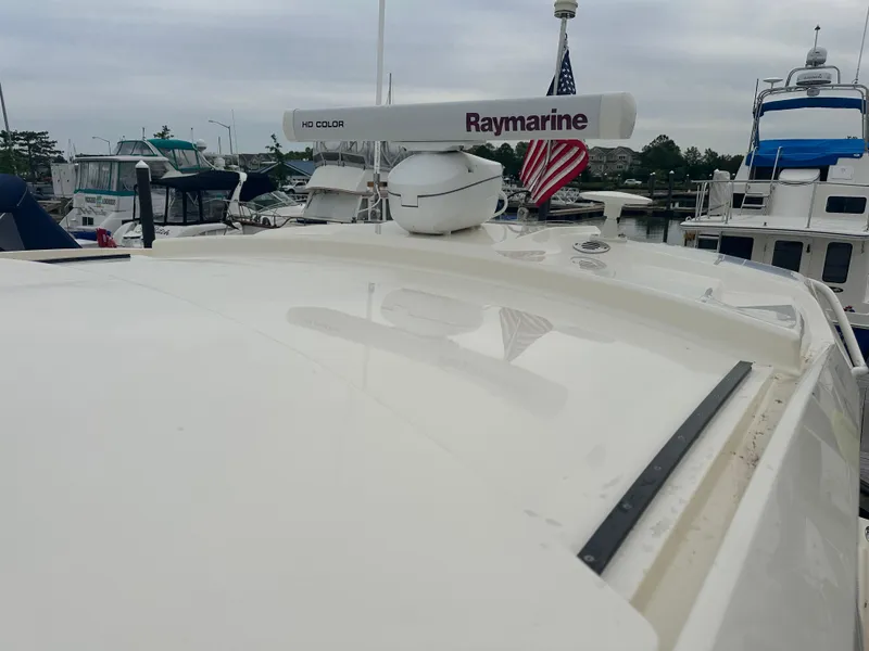 Slide: The Image of 2014 Pursuit SC 365i Sport Coupe with Raymarine radar, docked in a marina. - 22