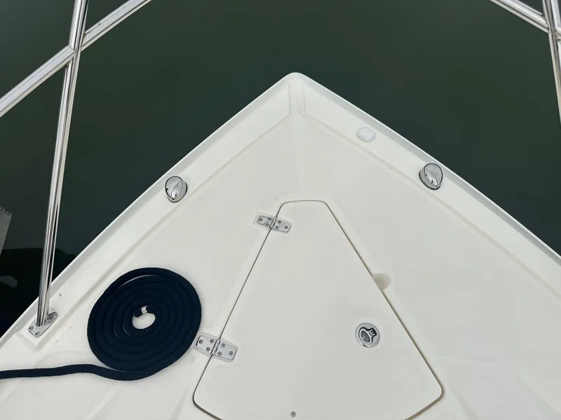 Slide: The Image of Bow of 2014 Pursuit SC 365i Sport Coupe with coiled rope on deck. - 25