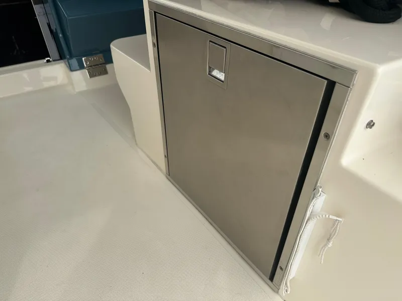 Slide: The Image of Stainless steel storage compartment on 2014 Pursuit SC 365i Sport Coupe boat deck. - 28