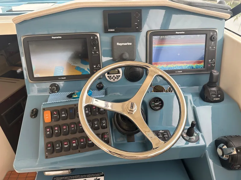 Slide: The Image of Control panel of a 2014 Pursuit SC 365i Sport Coupe with Raymarine displays. - 29