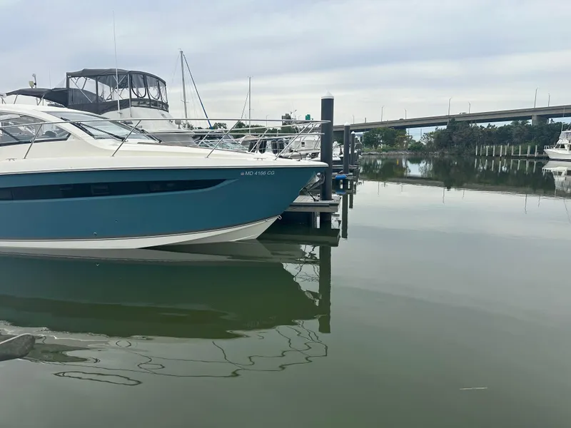 Slide: The Image of 2014 Pursuit SC 365i Sport Coupe docked in a calm marina. - 3