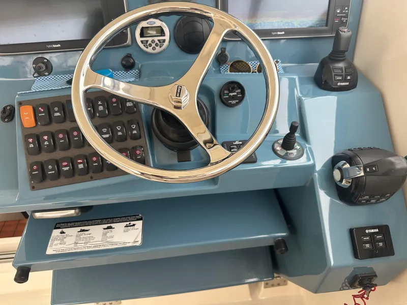 Slide: The Image of Control panel of a 2014 Pursuit SC 365i Sport Coupe with steering wheel and navigation instruments. - 30