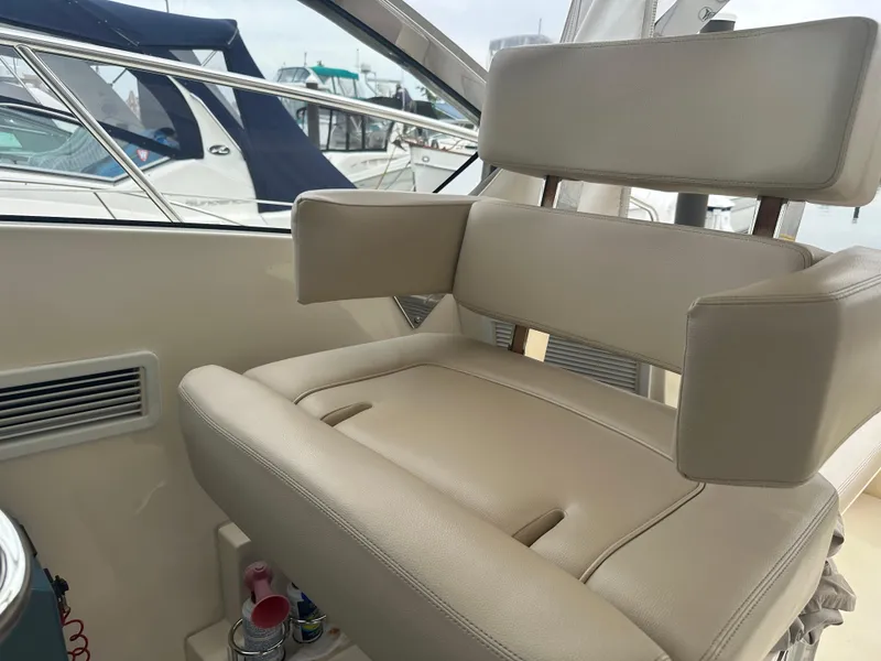 Slide: The Image of 2014 Pursuit SC 365i Sport Coupe interior with beige seating and armrests. - 31