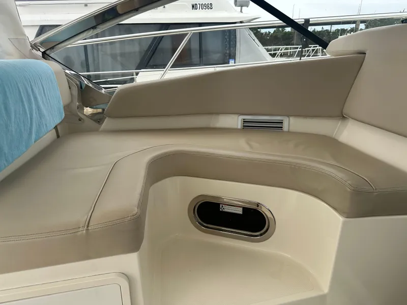 Slide: The Image of 2014 Pursuit SC 365i Sport Coupe interior seating with beige upholstery and window view. - 33