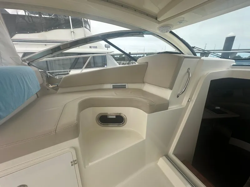 Slide: The Image of 2014 Pursuit SC 365i Sport Coupe interior with beige seating and sleek design. - 34