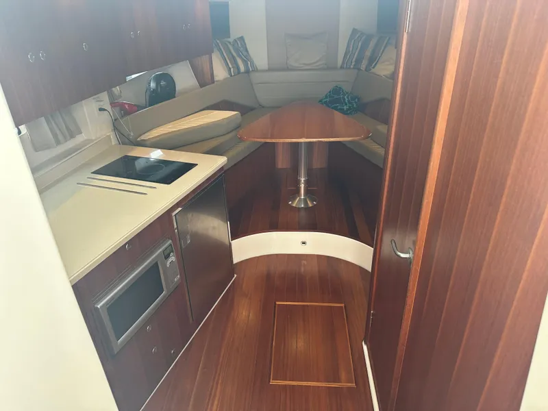 Slide: The Image of 2014 Pursuit SC 365i Sport Coupe interior with kitchenette and seating area. - 35