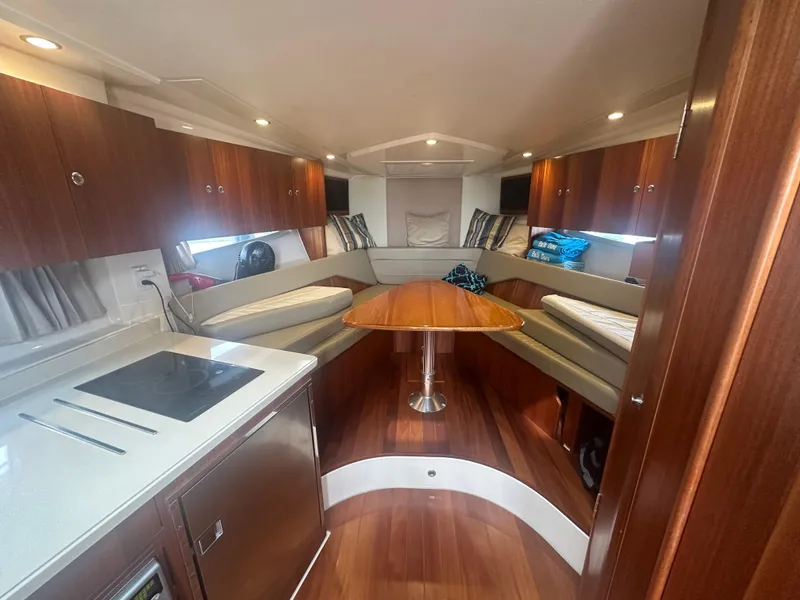 Slide: The Image of Luxurious interior of 2014 Pursuit SC 365i Sport Coupe with wood finishes and seating area. - 39