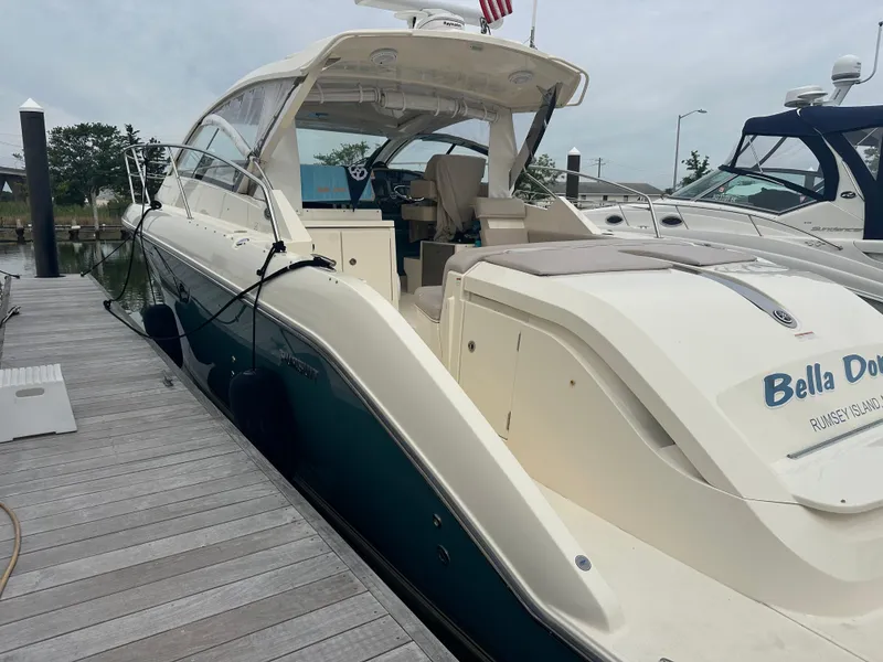 Slide: The Image of 2014 Pursuit SC 365i Sport Coupe docked, showcasing sleek design and luxurious features. - 4