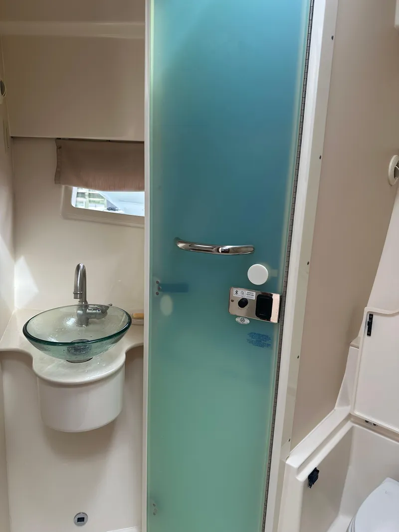 Slide: The Image of 2014 Pursuit SC 365i Sport Coupe bathroom with frosted glass door and modern sink. - 45