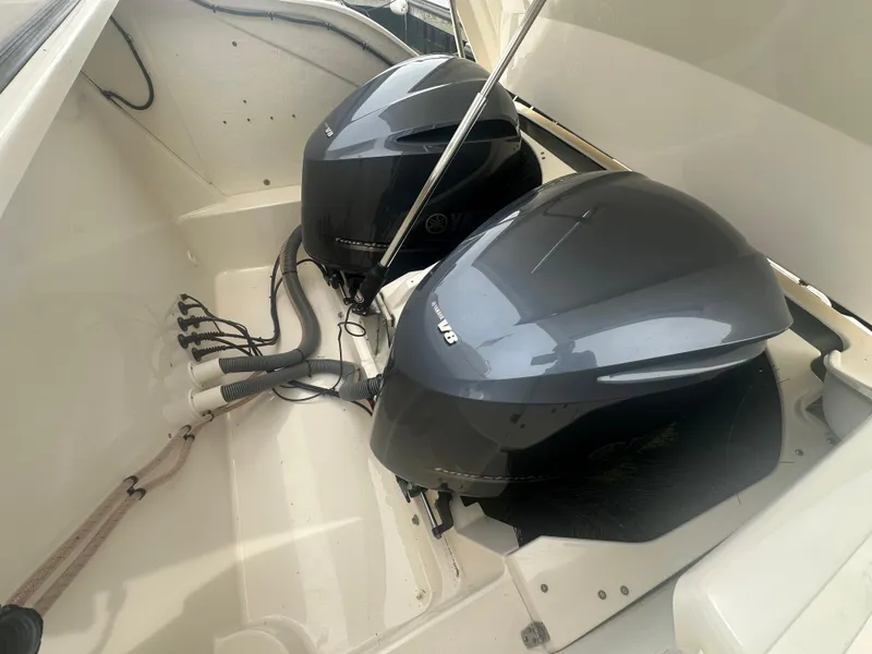 Slide: The Image of 2014 Pursuit SC 365i Sport Coupe with dual outboard engines in boat compartment. - 47