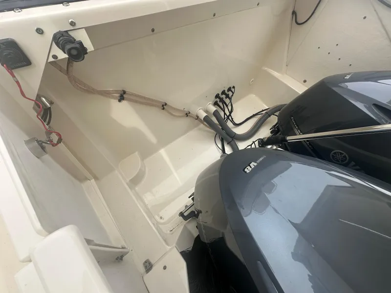 Slide: The Image of 2014 Pursuit SC 365i Sport Coupe boat engine compartment with dual Yamaha outboard motors. - 48