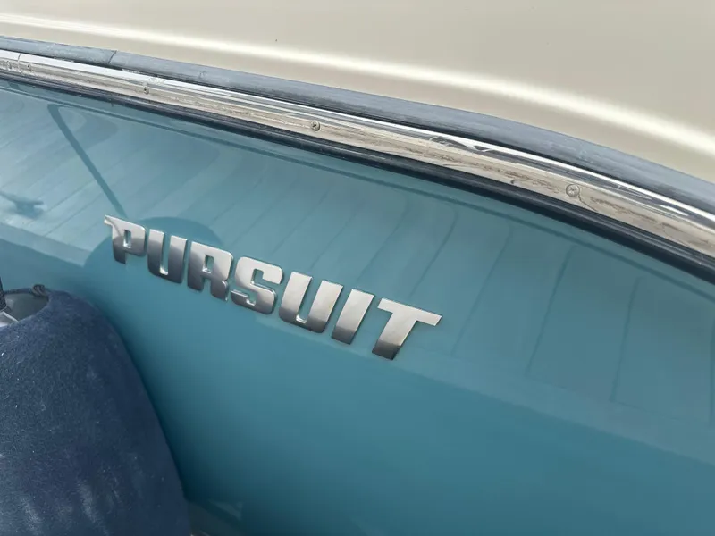 Slide: The Image of 2014 Pursuit SC 365i Sport Coupe boat with chrome logo on blue hull. - 6