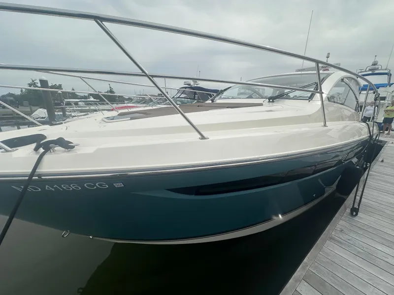 Slide: The Image of 2014 Pursuit SC 365i Sport Coupe docked at marina, side view. - 7