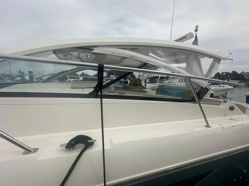 Slide: The Image of 2014 Pursuit SC 365i Sport Coupe docked, showcasing sleek design and modern features. - 8