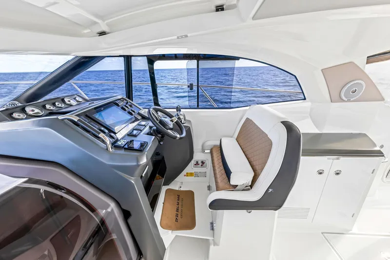 Slide: The Image of 2018 Jeanneau Leader 36 helm with modern controls and ocean view. - 10