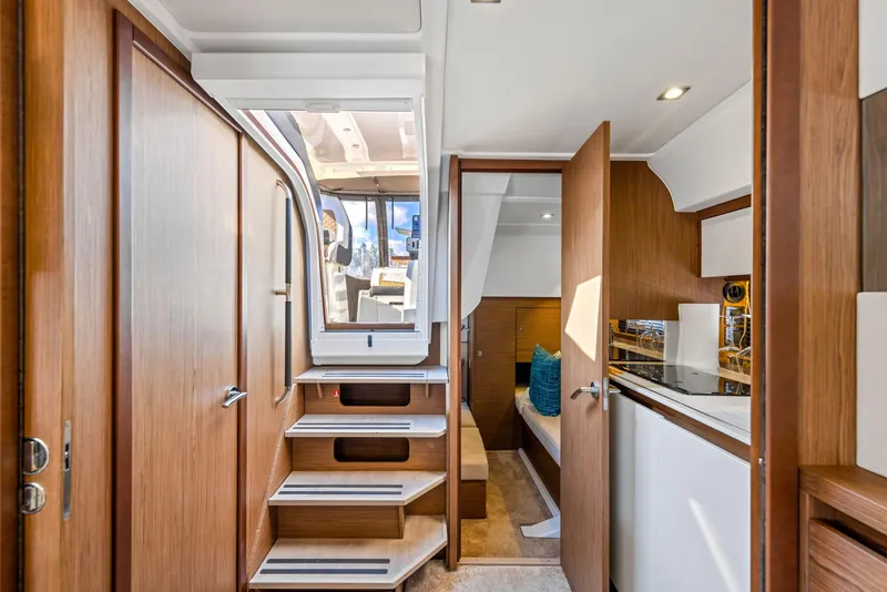 Slide: The Image of Interior of 2018 Jeanneau Leader 36 yacht, featuring modern wood finishes and compact design. - 11