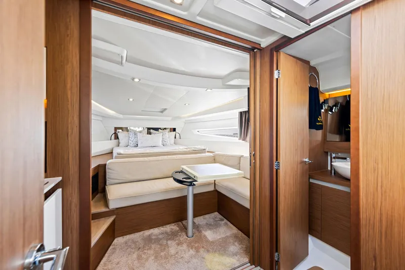 Slide: The Image of Luxurious interior of 2018 Jeanneau Leader 36 yacht with cozy seating and elegant wood finishes. - 12