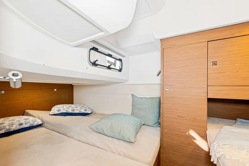 Slide: The Image of Cabin interior of 2018 Jeanneau Leader 36 with twin beds and wooden cabinetry. - 15