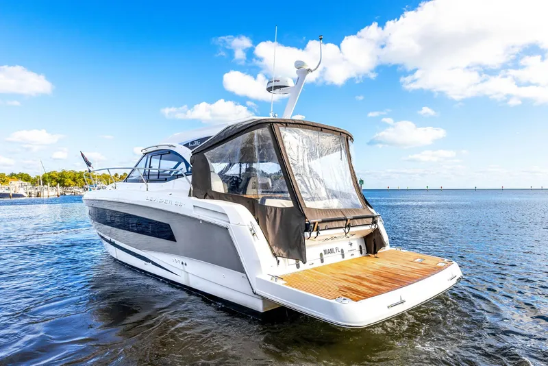 Slide: The Image of 2018 Jeanneau Leader 36 yacht on calm water under a clear blue sky. - 2