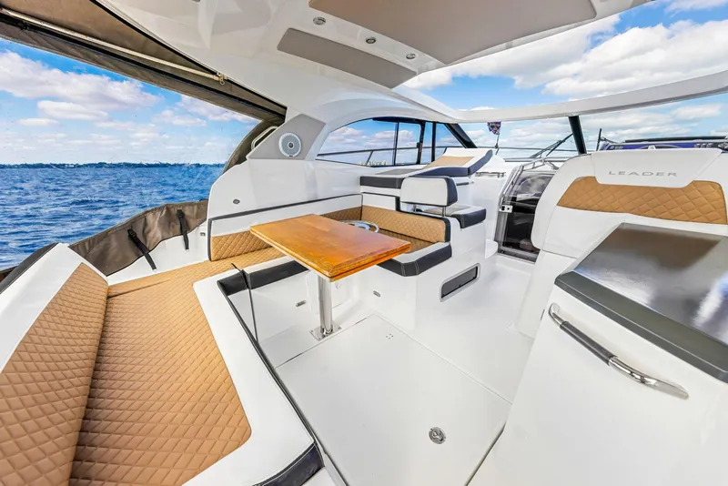 Slide: The Image of 2018 Jeanneau Leader 36 yacht interior with luxurious seating and ocean view. - 7